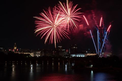 Vibrant fireworks illuminating cityscape at night