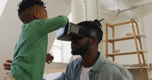 Father and Son Experiencing Virtual Reality at Home - Download Free Stock Images Pikwizard.com
