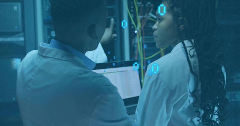 IT Technicians Analyzing Server Data in Modern Data Center Environment