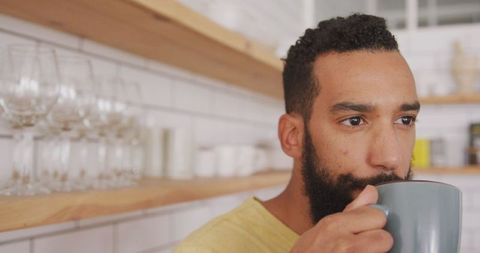 Man Sipping Tea in Cozy Kitchen Setting