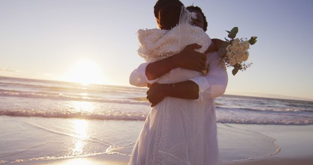 African american couple in love getting married, embracing on the beach at sunset - Download Free Stock Photos Pikwizard.com
