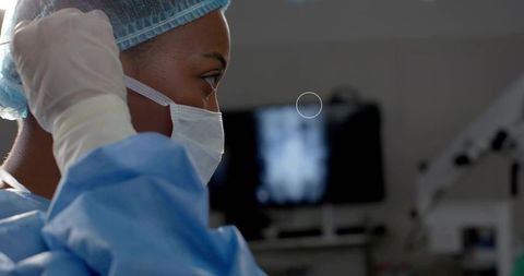 Surgeon preparing in operating room examining x-ray monitor