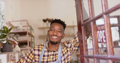 Smiling Male Potter Welcoming Customers in Shop Doorway