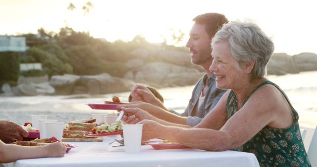 Multigenerational Family Enjoying Beach Picnic at Sunset - Download Free Stock Images Pikwizard.com