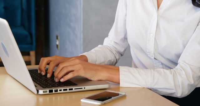 Businessperson Typing on Laptop in Office Workspace - Download Free Stock Images Pikwizard.com