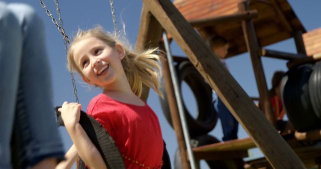 Joyful Child on a Playground Swing Under Sunny Skies - Download Free Stock Images Pikwizard.com