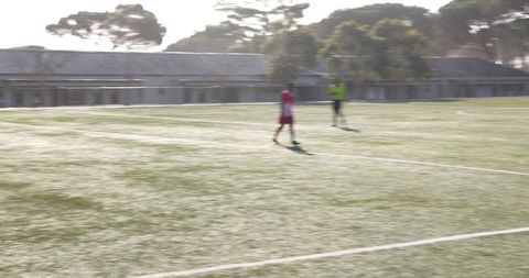 Blurred youth soccer players on bright morning