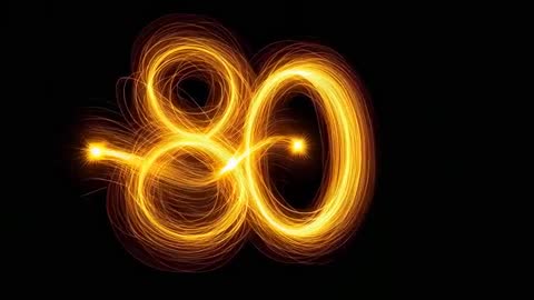 Drawing glowing double-loop 80 with spinning golden light trails motion video