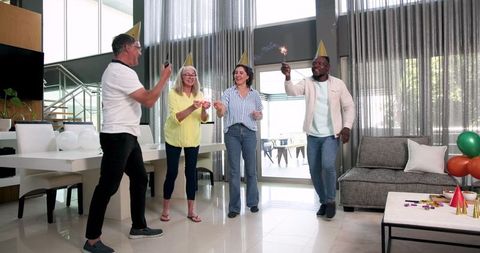 Joyful office celebration with diverse colleagues holding sparklers