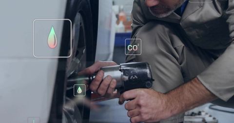 Mechanic Tightening Wheel Stressing Environmental Awareness