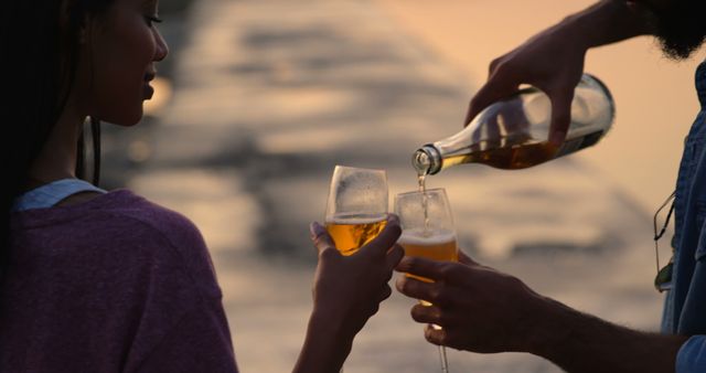 Couple Toasting with Champagne at Sunset by the Beach - Download Free Stock Images Pikwizard.com