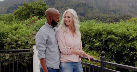 Diverse Elderly Couple Enjoying Time Outdoors on Balcony