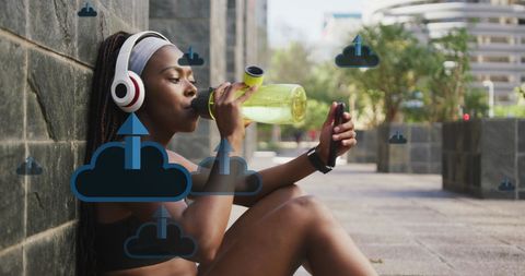 Athletic Woman Drinking Water Exploring Cloud Technology