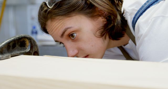 Focused Carpenter Measuring Wood Piece in Workshop - Download Free Stock Images Pikwizard.com