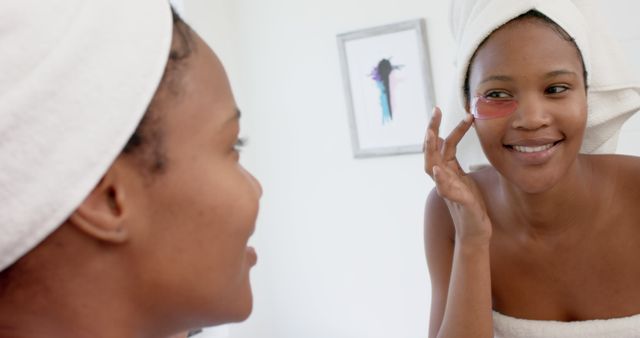 African American Woman Applying Under-Eye Mask in Bathroom - Download Free Stock Images Pikwizard.com