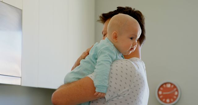 Father Holding Baby in Home Kitchen - Download Free Stock Images Pikwizard.com