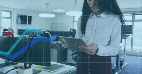 businesswoman interacts with digital interface displaying statistics on a tablet while modern colleagues collaborate in office background. useful for marketing materials focused on workplace analytics, technology integration, and collaborative environments showcasing agile working or data-driven decision-making.