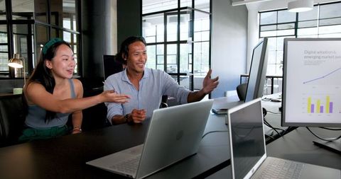 Diverse Colleagues Discussing Business Analytics in Modern Office