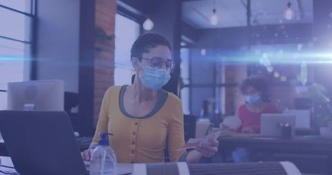 Female Professionals in Masks Working in Modern Office with Light Effects