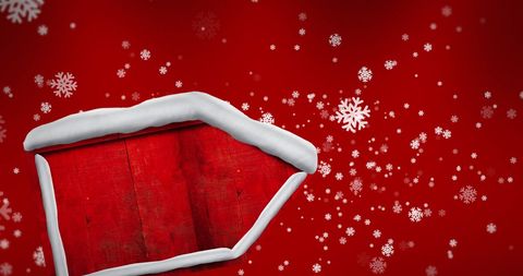 Festive Wooden Sign with Falling Snowflakes on Red Background