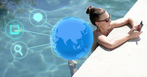 Woman checking smartphone poolside with augmented reality globe and social icons