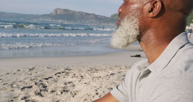 Serene Senior Man Enjoying Peaceful Beach Ocean View - Download Free Stock Images Pikwizard.com