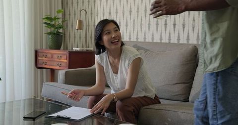 Enthusiastic Business Discussion in Modern Living Room Setting