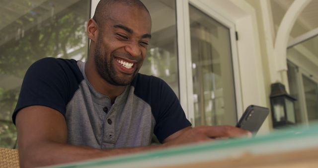 Smiling Man Using Smartphone at Home Patio - Download Free Stock Images Pikwizard.com