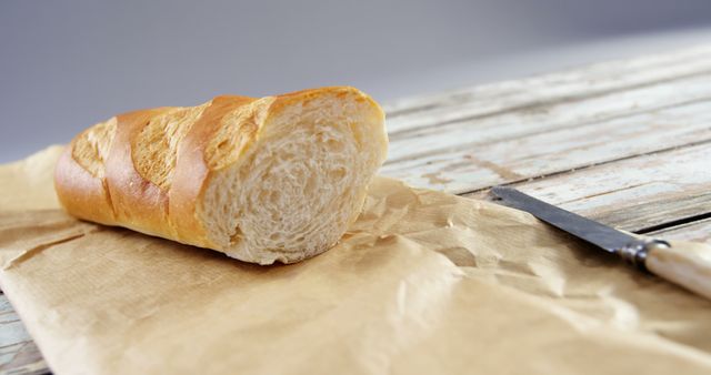 Rustic Baguette on Brown Paper with Knife - Download Free Stock Images Pikwizard.com