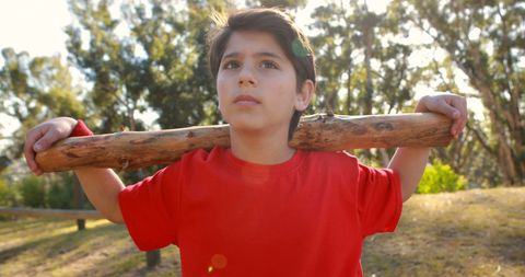 Young Boy Embracing Adventure with Wooden Stick Outdoors - Download Free Stock Images Pikwizard.com