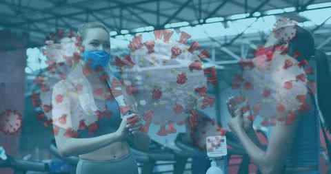 Women in Gym Amid COVID-19 Precautions with Floating Virus Cells