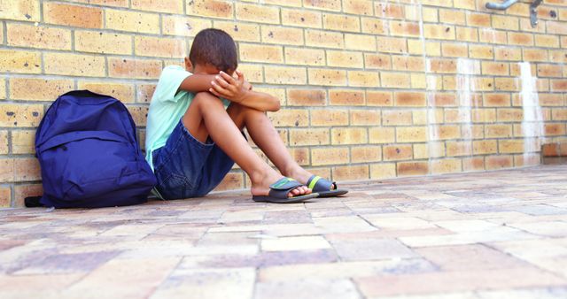 Sad schoolboy sitting alone on school ground at school 4k - Download Free Stock Photos Pikwizard.com
