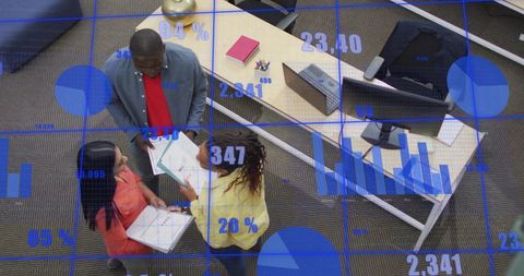 Diverse Team Discussing Data in Modern Office with Digital Charts Overlay