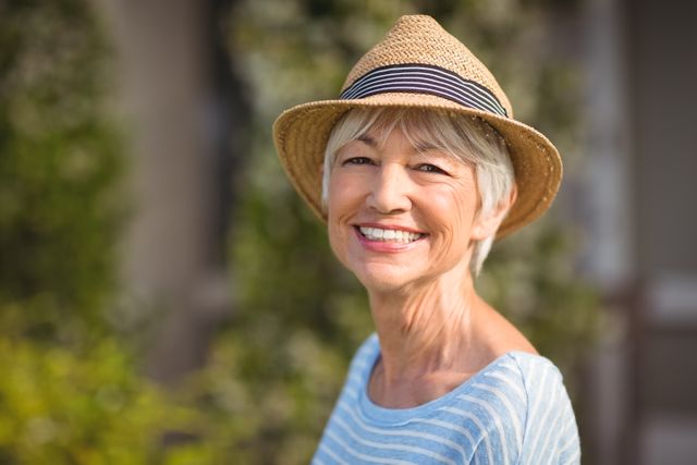 Portrait of a happy senior woman in straw hat