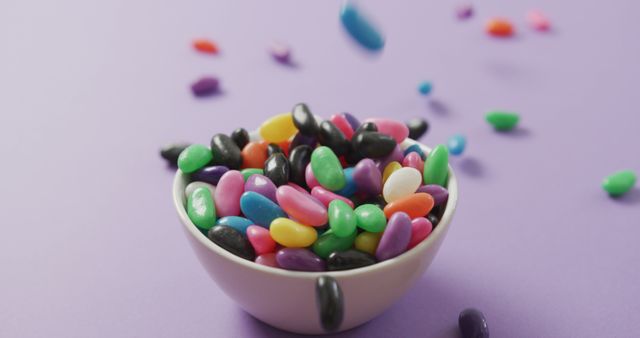 Colorful Jelly Beans Falling into Bowl on Light Purple Background - Download Free Stock Images Pikwizard.com