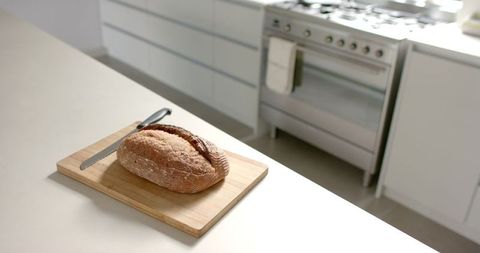 Fresh Loaf on Wooden Board in Bright Modern Kitchen