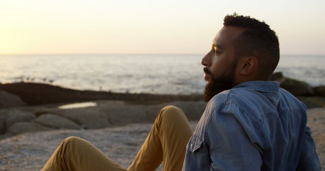 Contemplative Man Watching Sunset by Ocean - Download Free Stock Images Pikwizard.com
