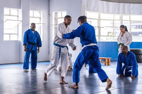 Martial Arts Training Session in Dojo with Diverse Class