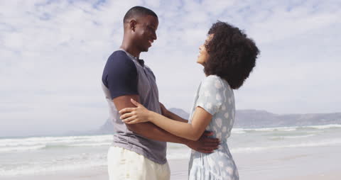 Romantic Couple Embracing on Serene Beach Day