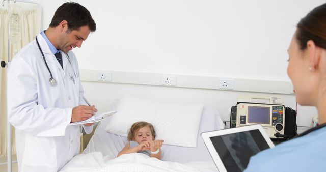 Doctors Evaluating Young Patient in Hospital Bed - Download Free Stock Images Pikwizard.com