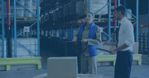 Warehouse teamwork: diverse staff examining inventory