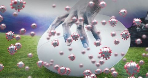 Athlete wearing cleats gripping rugby ball amidst graphic virus particles on field