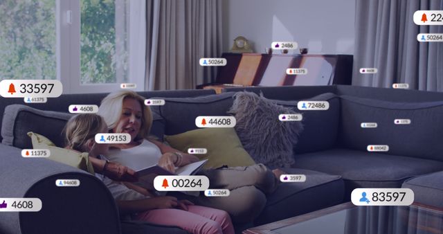 Mother and child sitting on gray couch in modern, bright living room with large windows. Various social media notification icons are superimposed around them, symbolizing digital interaction. Ideal for themes related to family time, social media, modern technology, and digital communication.