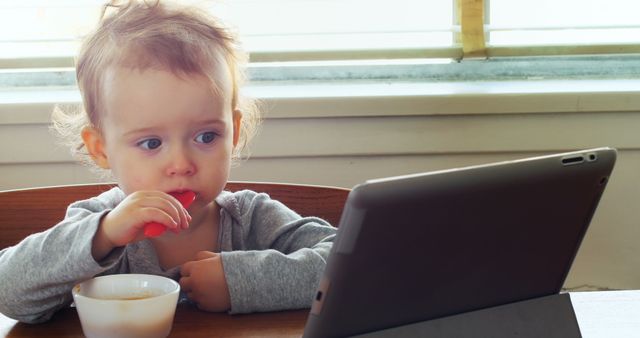 Toddler Engaged with Tablet During Breakfast Time - Download Free Stock Images Pikwizard.com