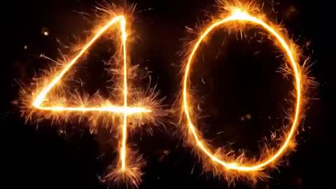 Slow Motion Sparkler Light Painting Forming Number 40 with Golden Sparks and Trails