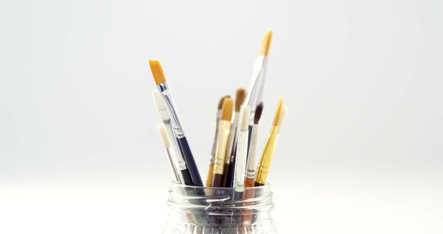 Assorted Paintbrushes in Clear Glass Jar on White Background - Download Free Stock Images Pikwizard.com