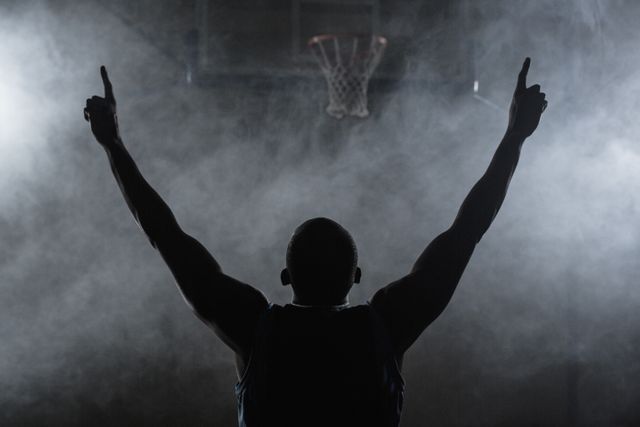 Rear view of a basketball player with his arms in the air - Download Free Stock Photos Pikwizard.com