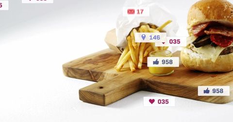 Gourmet cheeseburger with bacon and fries on wooden board with social media icons