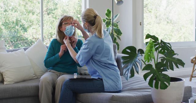 Caregiver Assisting Senior Woman with Face Mask at Home - Download Free Stock Images Pikwizard.com