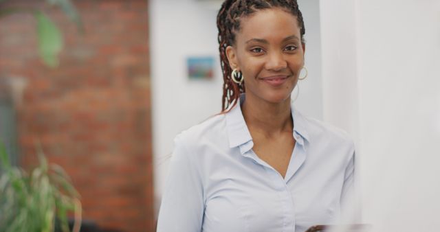 Confident Young Businesswoman Smiling in Office Environment - Download Free Stock Images Pikwizard.com